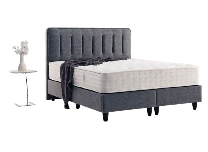 Robustes dunkelgraues Bett mit fließenden Linien auf stabilen Füßen